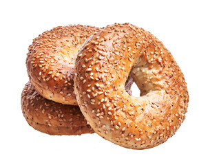 Three stacked sesame bagels isolated on a white background, depicting a fresh, baked, savory breakfast option.