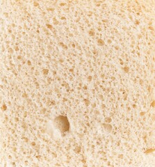 Close-up texture of fresh white bread with visible porous crumb structure, embodying the concept of bakery and nutrition.