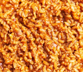 Close-up view of delicious, creamy risotto with parmesan and cooked grains, ideal for italian cuisine concepts.