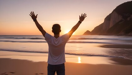 Fototapeta premium A traveling man raising up his arms in sunset at beach