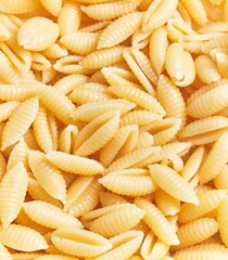 Close-up view of uncooked italian pasta fusilli background illustrating food and cuisine.