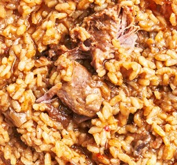 Close-up of a traditional meat and rice dish, likely a culinary staple in specific cultures.