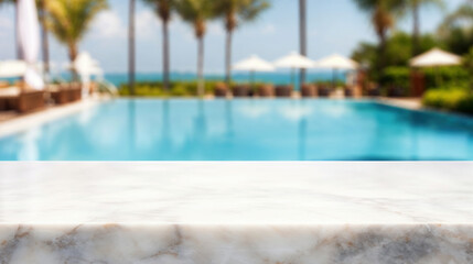 Fototapeta premium White marble countertop with a blurred background of a resort pool and ocean view