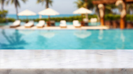 Marble tabletop with empty space overlooking blurred resort pool, lounge chairs, and sun umbrellas for copy placement