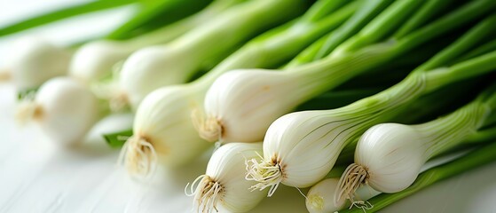 Fototapeta premium Fresh green onions on a white background, closeup, bright natural light, high detail