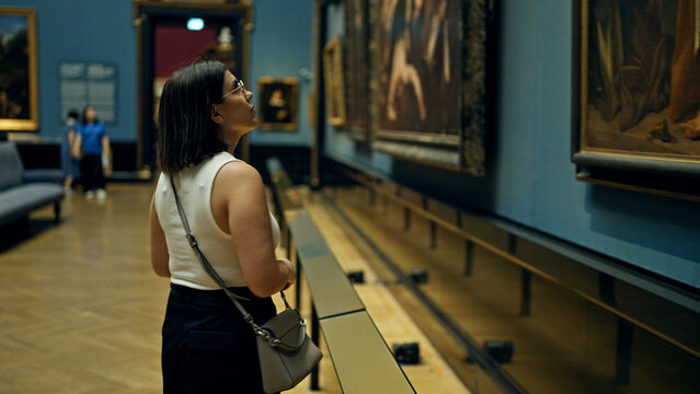 Young beautiful hispanic woman visiting art gallery at Art Museum in Vienna