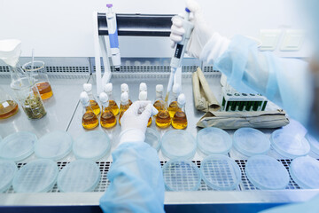 female laboratory assistant conducts research, chemical analysis, analysis of bacteria