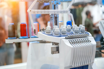 Threads on a sewing machine in loops from spools during automatic operation.