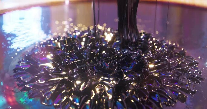 Ferromagnetic fluid moving under the influence of strong neodymium magnets. Ferromagnetic fluid creates amazing drawings spikes in magnetic field, transmits the directions of magnetic fields