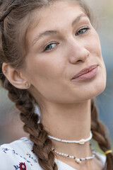 Attractive young caucasian woman is enjoying warm sunny weather walking outside. Brown-haired. Relaxation concept