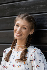 Attractive young caucasian woman is enjoying warm sunny weather walking outside. Brown-haired. Relaxation concept