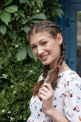 Portrait of young happy beautiful woman smiling and standing and touch hair