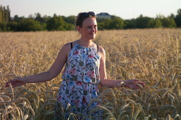 Girl in a wheat field with wucher, summer atmosphere lifestyle.