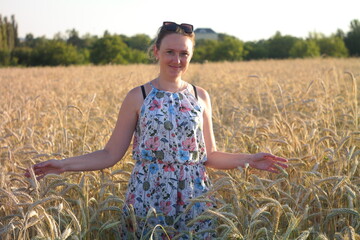 Girl in a wheat field with wucher, summer atmosphere lifestyle.
