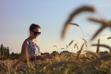 Girl in a wheat field with wucher, summer atmosphere lifestyle.