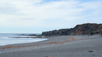 Icelandic seacape with volcanic rock formations and lava fields in summer near Dritvik, Snaefellsnes peninsula