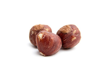 Close-up of three hazelnuts isolated on a white background. Ideal for food and health-related visuals