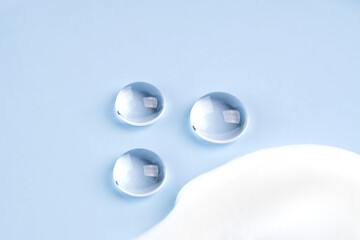 Cosmetic smears and translucent globes on a soft blue background