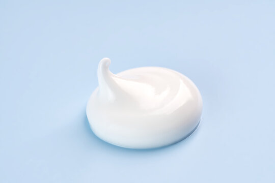 Elegant cosmetic cream smear on a serene blue background