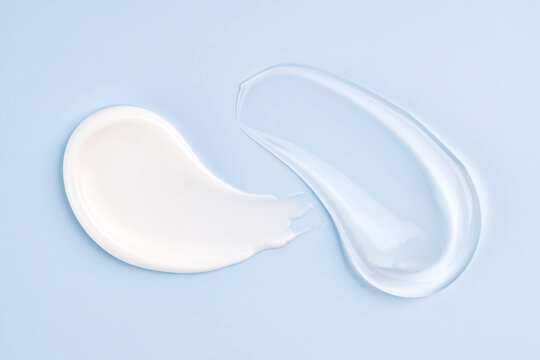 Cosmetic smears of cream presented on a blue background