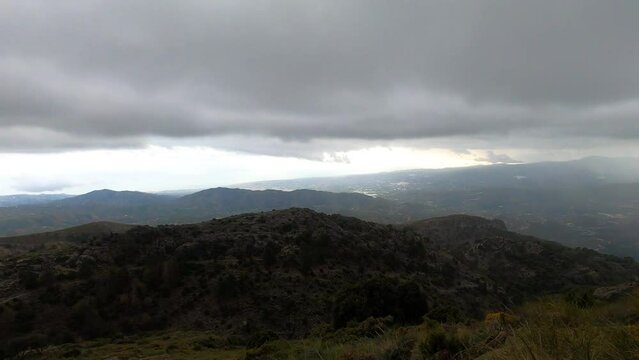 Fog and clouds on hiking trail to Maroma peak in thunderstorm day, Sierra Tejeda, Spain 