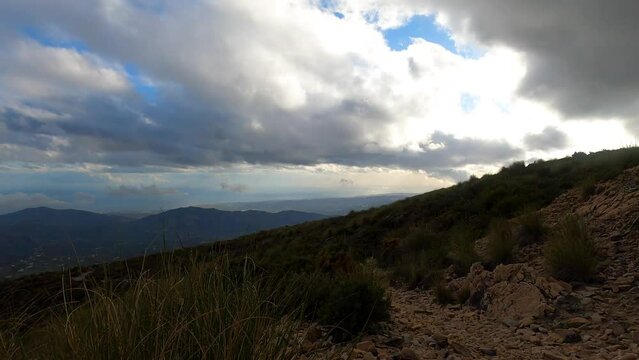 Fog and clouds on hiking trail to Maroma peak in thunderstorm day, Sierra Tejeda, Spain 