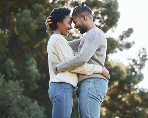 Fototapeta premium Love, hug and happy couple in countryside for care, holiday and adventure or winter camping trip. Black man, woman and embrace outdoor for support, comfort and together with sunshine in forest