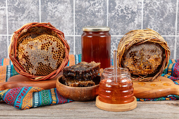 Magical honeycomb close up, Honey harvesting, honey picking. Organic honeycomb (Turkish Karakovan Honey). Organic honeycomb in jar with honey dipper on vintage wooden background.