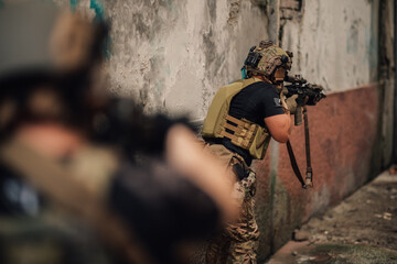 Group of air soft fighters with weapons shooting at enemy indoors.