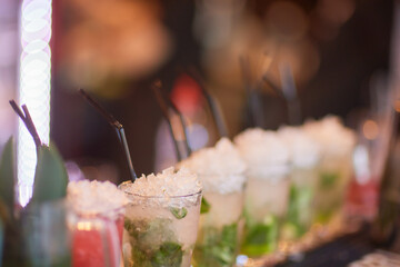 Enjoy a lively party with cocktails garnished with mint and ice for a refreshing experience
