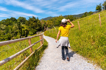 Fototapeta premium A woman walking on the path in the Jaizubia marsh in the town of Hondarribia or Fuenterrabia in Gipuzkoa. Basque Country