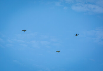 Three RAF typhoons flying, flying in formation back to their respected air fields after taking part in the kings fly past on a beautiful summers day with blue skies and slight cloud