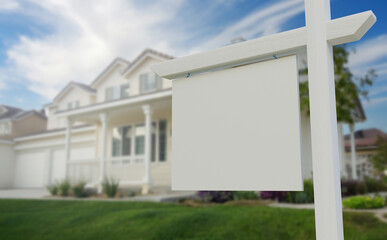 Blank Real Estate Sign in Front of Beautiful House.