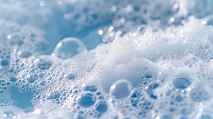Soap foam on the water on a blue background. Foam texture as background for image. Soap bubbles on the background of foam