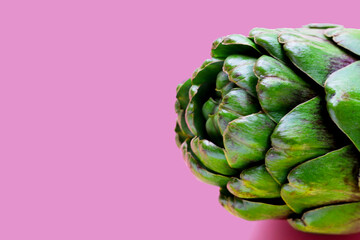 Fototapeta premium Purple artichoke on pink background.