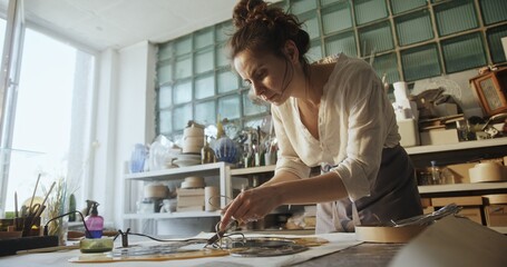 Glass Artist Soldering Connections in Floral Glass Mirror