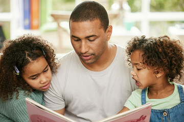 Obraz premium Father, children and reading book in home for family bonding, learning and development in lounge. Dad, kids and together in house for storytelling or learning, parent teaching for childhood growth