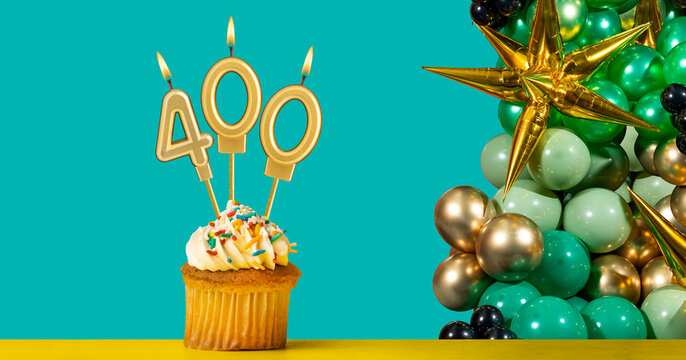 Birthday candle number 400 - Cupcake with decoration on a green background