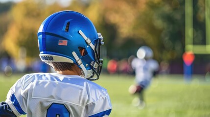 Fototapeta premium Back view of a boy in a football uniform playing on a field, sports career dreams, aspiring athlete