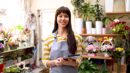Young woman running a flower store