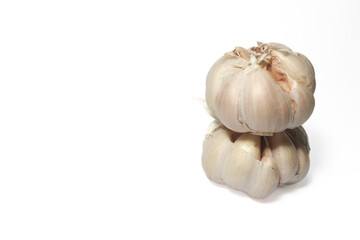 two garlic cloves stacked on top of each other. isolated background. white background. Object in the middle right