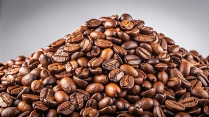 Fototapeta premium A pile of coffee beans isolated on a background, coffee, beans, pile, isolated,background, organic, aroma, caffeine, dark