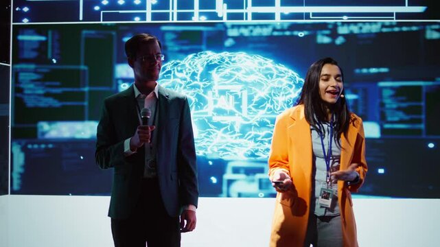 Tech specialists discussing during keynote summit presentation, exploring successful implementation of AI in driving forward businesses, sharing latest artificial intelligence innovations, camera B