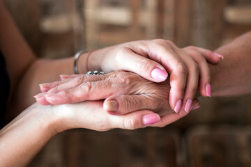 Two pairs of hand touching each other, together, helping hands
