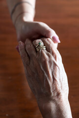 Two pairs of hand touching each other, together, helping hands