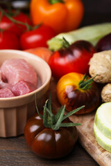 Cooking tasty stew. Fresh tomatoes and raw meat on wooden table