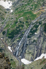 The cold valley of the five Spiš Lakes with a mountain hut, view from Lomnicke saddle High Tatras Slovakia