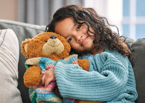 Portrait, hug or child with teddy bear for love, comfort and toy for support, therapy healing or play. Mexican girl, orphan and stuffed animal in home with happiness, kid and donation gift for game - Powered by Adobe