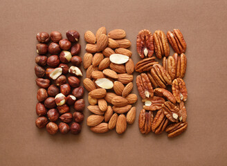 Creative layout made of hazelnut, almond, pecan nuts. Flat lay. Food concept. Nut pattern concept. Macro image.