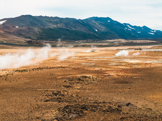 Aerial view of Hverir Geothermal Area in Iceland, capturing boiling mud pools, fumaroles, and the...